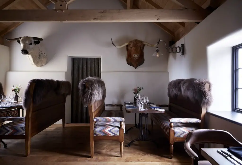 Dining room watched over by bulls heads